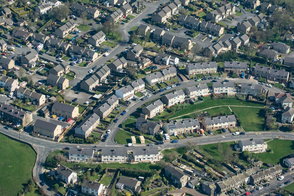 Aerial view of a residential neighborhood with curving streets, homes and green space