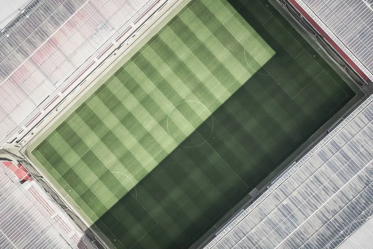 Top-down aerial view of a sports field and stadium seating